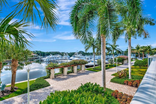 view of community with a water view and a dock