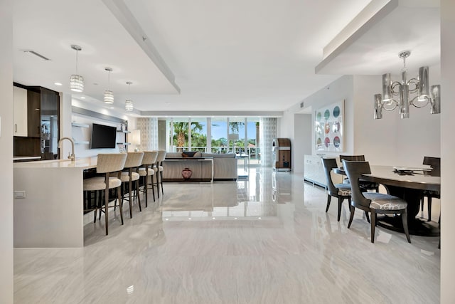 dining room with floor to ceiling windows, sink, and an inviting chandelier