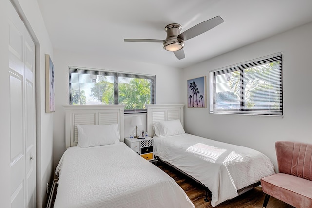 bedroom with ceiling fan, a closet, and hardwood / wood-style flooring