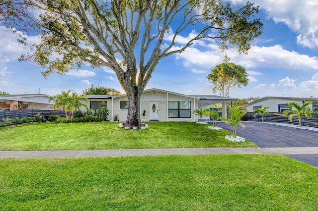 view of front of house with a front lawn and a carport