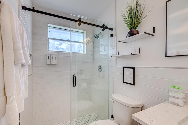 bathroom featuring toilet, tile walls, walk in shower, and vanity