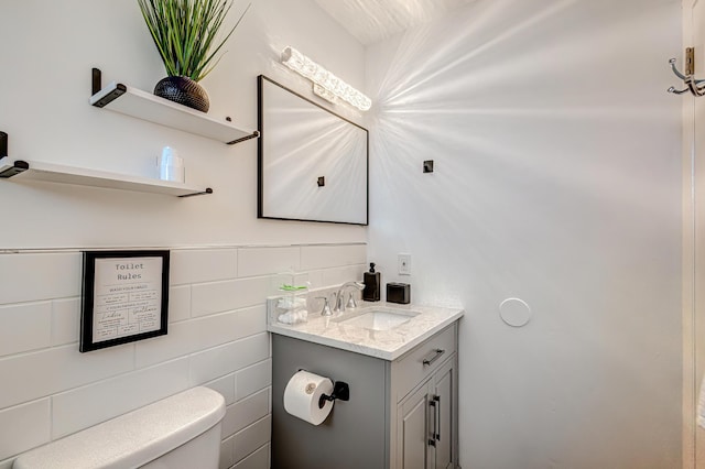 bathroom with toilet and vanity