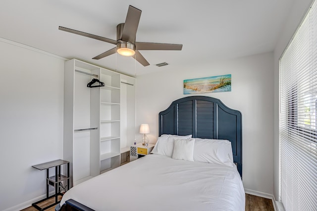 bedroom featuring ceiling fan and dark wood-type flooring