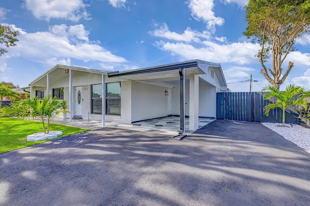 back of property featuring a carport