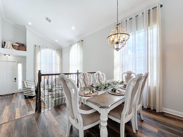 dining space featuring vaulted ceiling, dark hardwood / wood-style floors, a chandelier, and ornamental molding