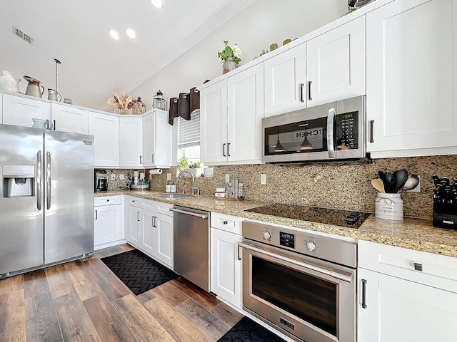 kitchen featuring tasteful backsplash, sink, white cabinetry, stainless steel appliances, and dark hardwood / wood-style flooring