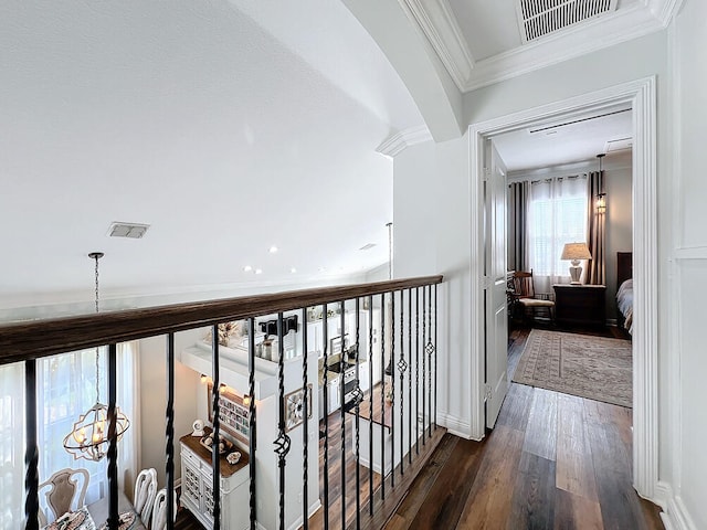 hallway with dark hardwood / wood-style flooring and ornamental molding