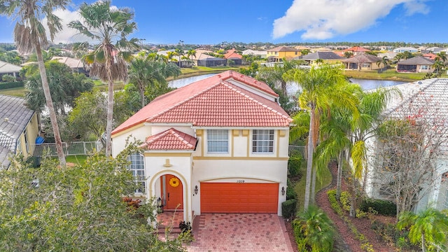 view of front of home featuring a garage and a water view