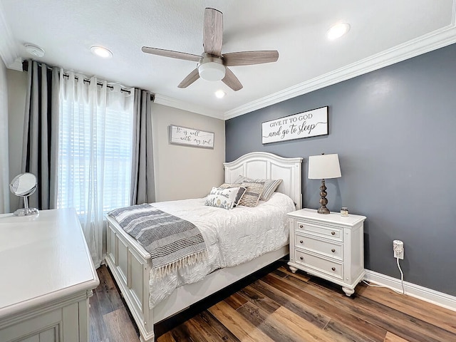 bedroom with dark wood-type flooring, ceiling fan, and ornamental molding