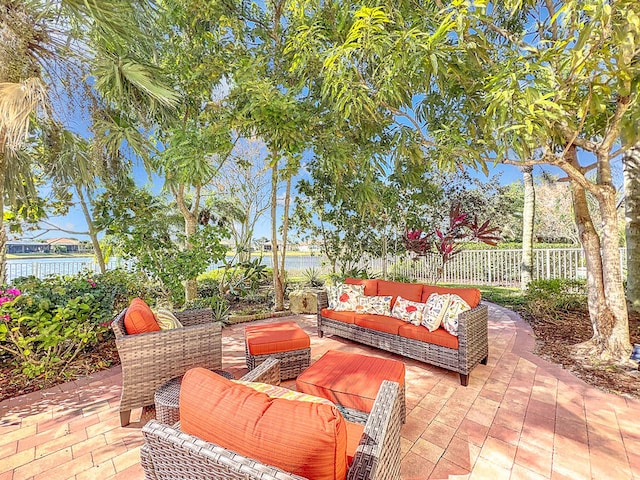 view of patio with an outdoor living space and a water view