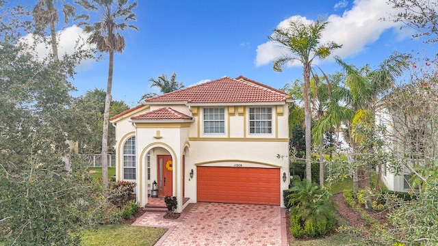 mediterranean / spanish-style home with a garage