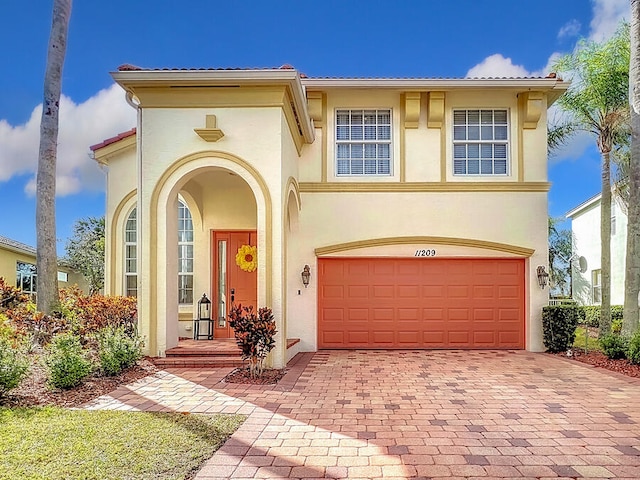 mediterranean / spanish-style house with a garage