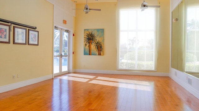 spare room with light wood-type flooring, ceiling fan, and french doors