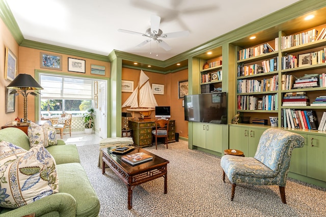 sitting room featuring light carpet, built in features, ceiling fan, and crown molding