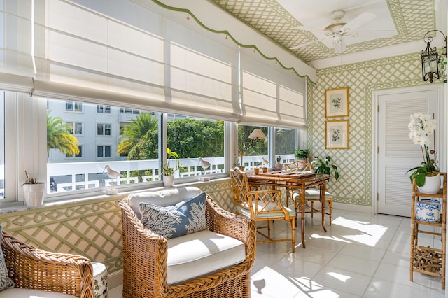 sunroom featuring ceiling fan