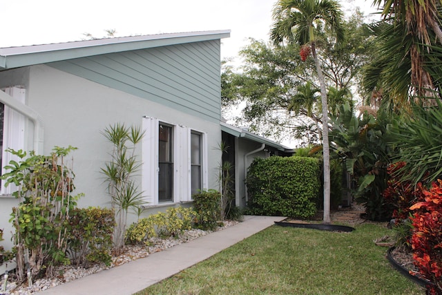 view of property exterior with a yard