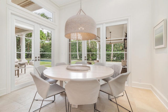 dining space featuring a towering ceiling and french doors