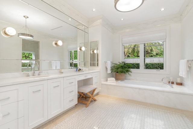 bathroom featuring tiled tub, vanity, crown molding, and tile patterned flooring