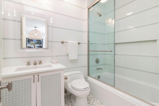 full bathroom with toilet, enclosed tub / shower combo, backsplash, tile walls, and vanity