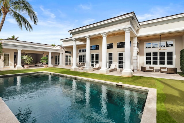 rear view of house featuring ceiling fan, an outdoor hangout area, and a patio area