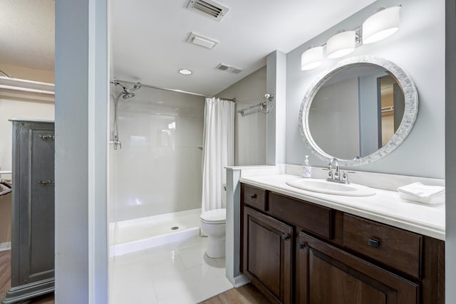 bathroom with toilet, vanity, and curtained shower