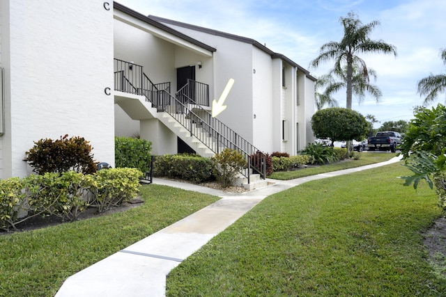 view of home's community featuring a lawn