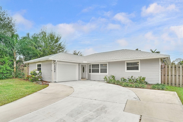 ranch-style home featuring a garage and a front lawn