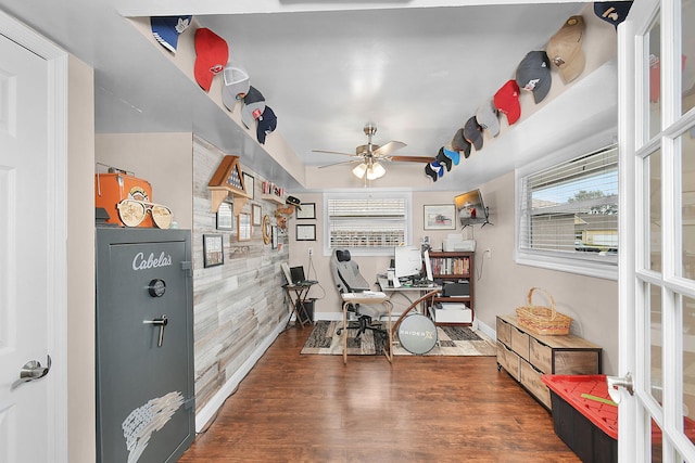 home office with dark wood-type flooring and ceiling fan