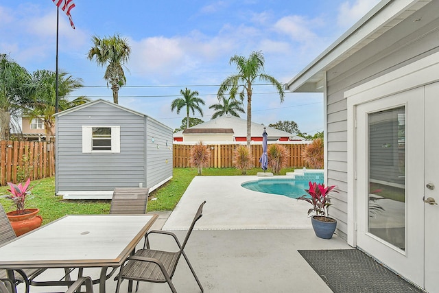 view of patio featuring a storage shed and a fenced in pool