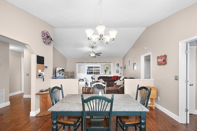 dining room with lofted ceiling, dark hardwood / wood-style floors, ceiling fan with notable chandelier, and a textured ceiling