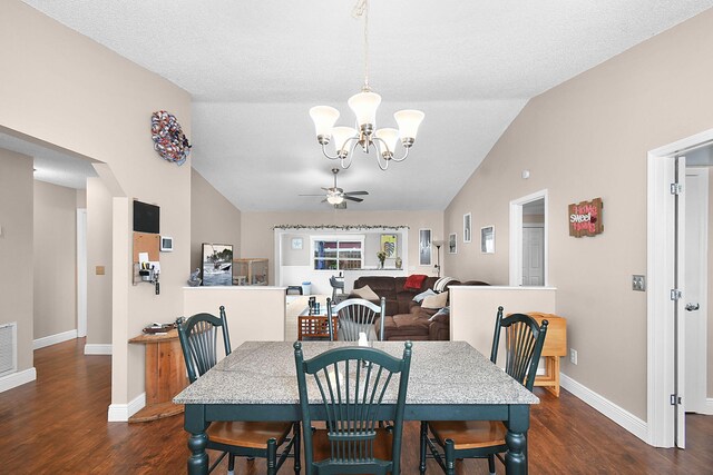 dining space with baseboards, arched walkways, ceiling fan with notable chandelier, vaulted ceiling, and dark wood-type flooring