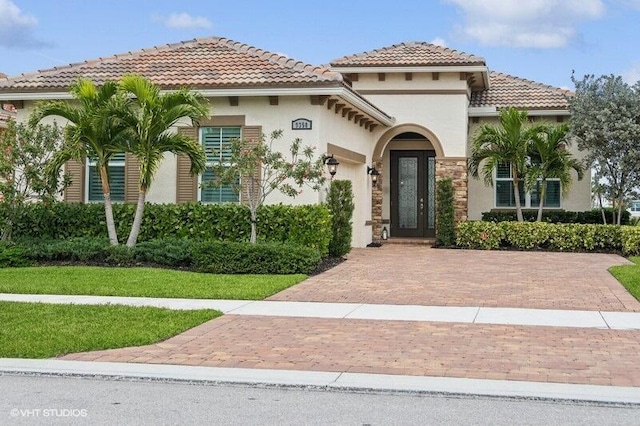 mediterranean / spanish-style home featuring a front lawn