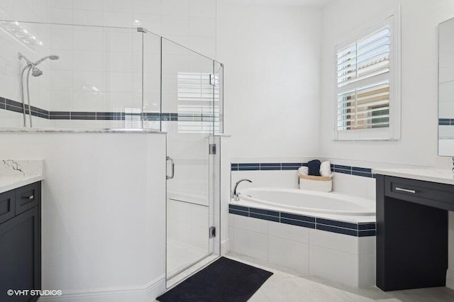 bathroom featuring separate shower and tub and vanity