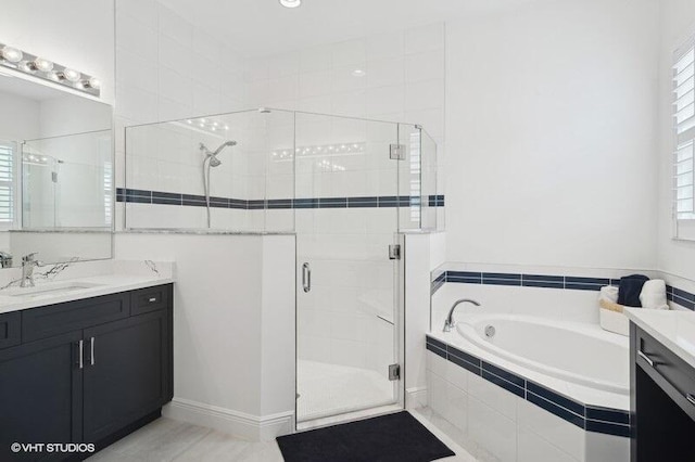 bathroom featuring tile patterned flooring, vanity, and plus walk in shower