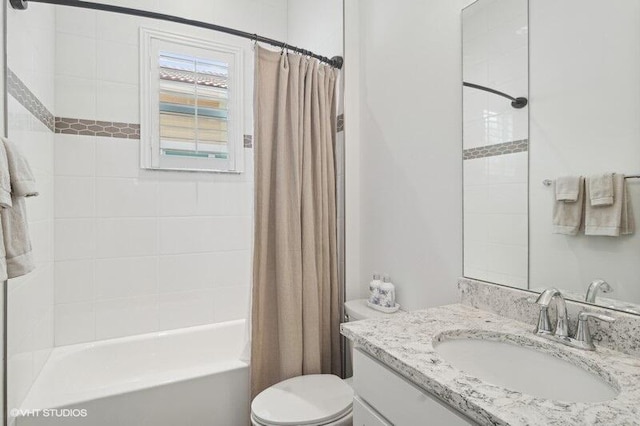 full bathroom with toilet, vanity, and shower / tub combo with curtain