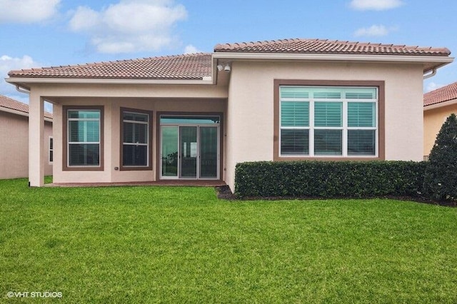 rear view of house with a lawn