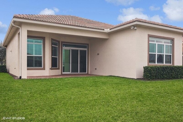 rear view of property with a yard