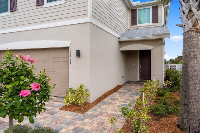 view of exterior entry with a garage