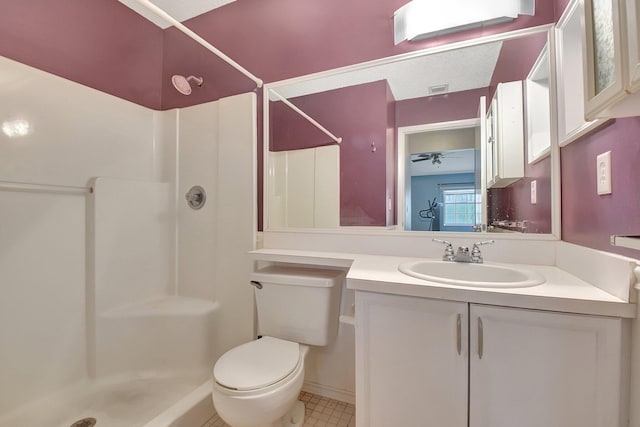 bathroom with toilet, vanity, ceiling fan, and a shower