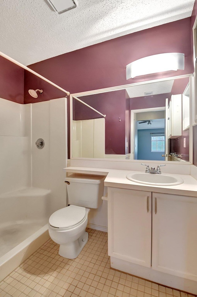 bathroom with toilet, tile patterned floors, walk in shower, and vanity