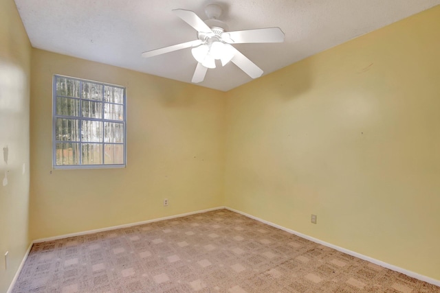 empty room with ceiling fan and light carpet