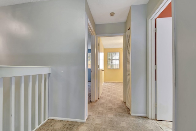 corridor with light colored carpet