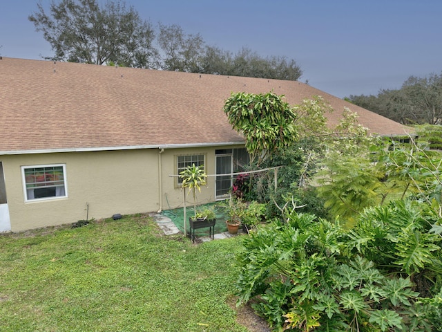 rear view of property featuring a yard