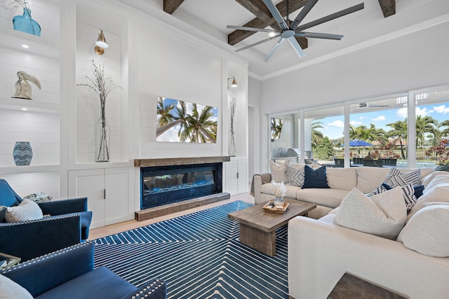 living room with coffered ceiling, hardwood / wood-style flooring, ceiling fan, beam ceiling, and a high ceiling