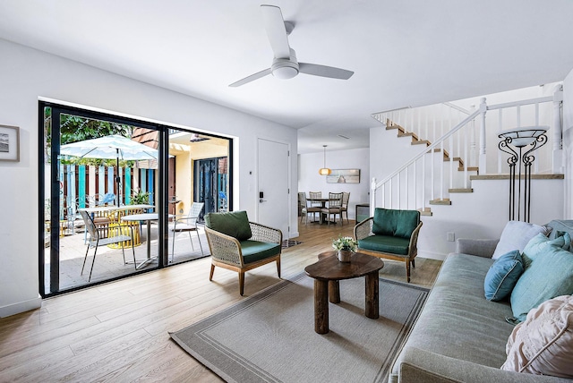 living room with ceiling fan and wood-type flooring