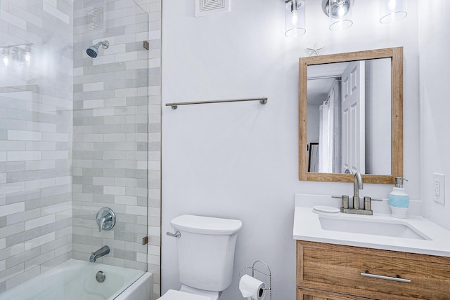 full bathroom featuring toilet, tiled shower / bath combo, and vanity