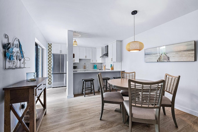 dining area featuring light hardwood / wood-style floors and sink