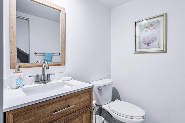 bathroom featuring toilet and vanity