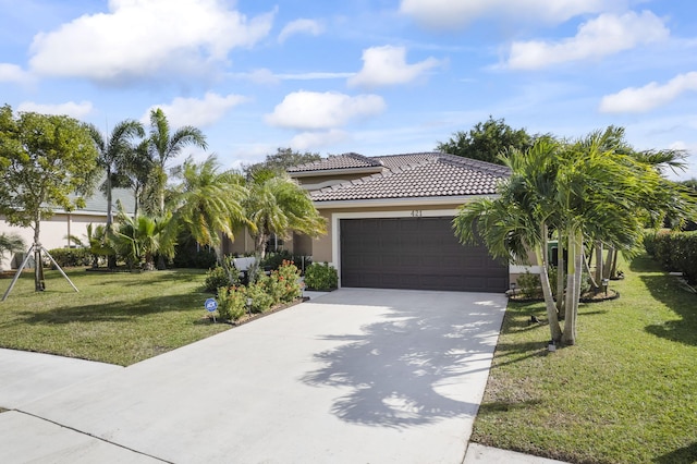 view of front of property with a garage and a front lawn