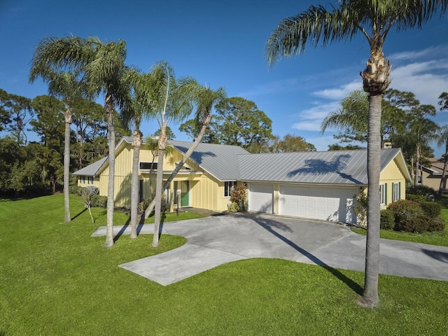 view of front of property with a garage and a front yard